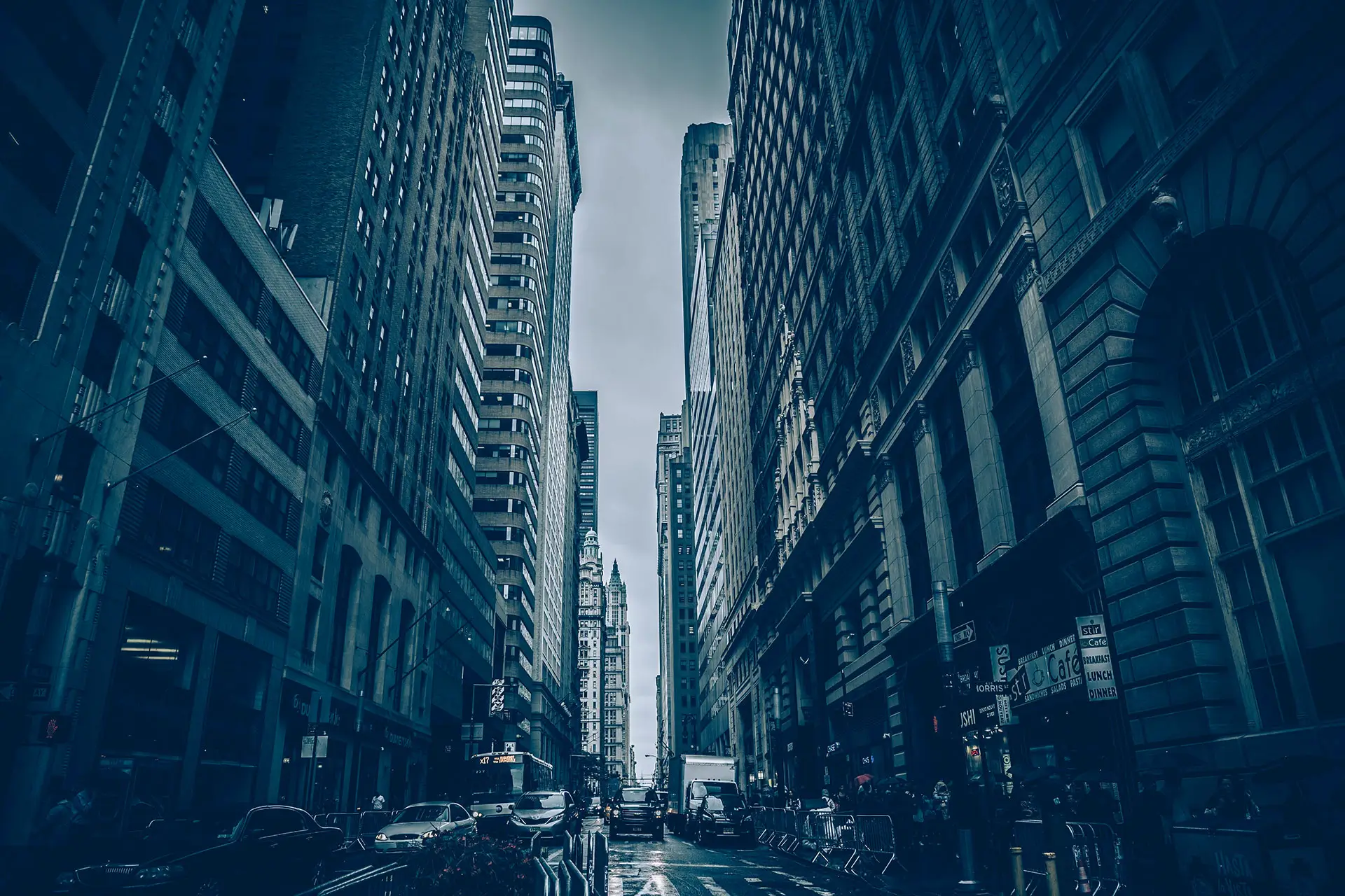 City street with tall buildings, moody atmosphere.